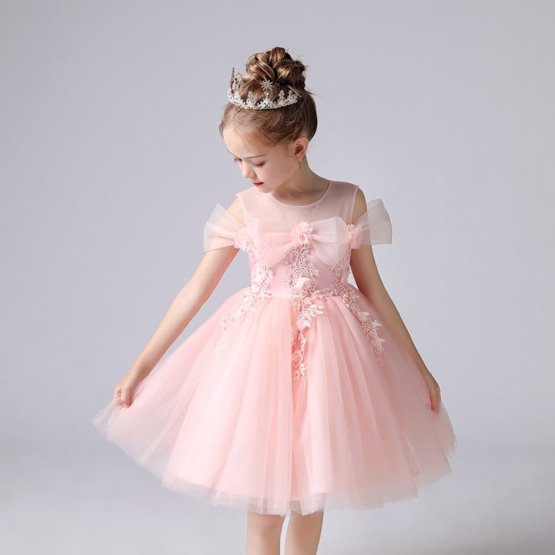 Toddler girl wearing an elegant pink butterfly pearl rhinestone lace princess party dress for a special event.
