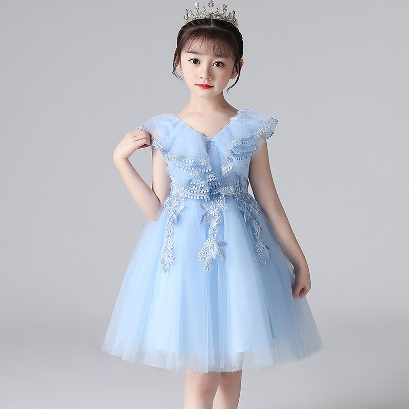 Full length view of a girls white butterfly pearl rhinestone lace princess party dress with flowing skirt.