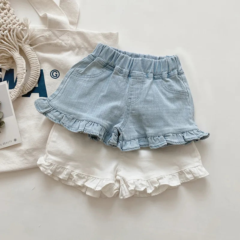 Girls' pink cotton ruffle shorts for playtime; soft, breathable toddler summer wear.