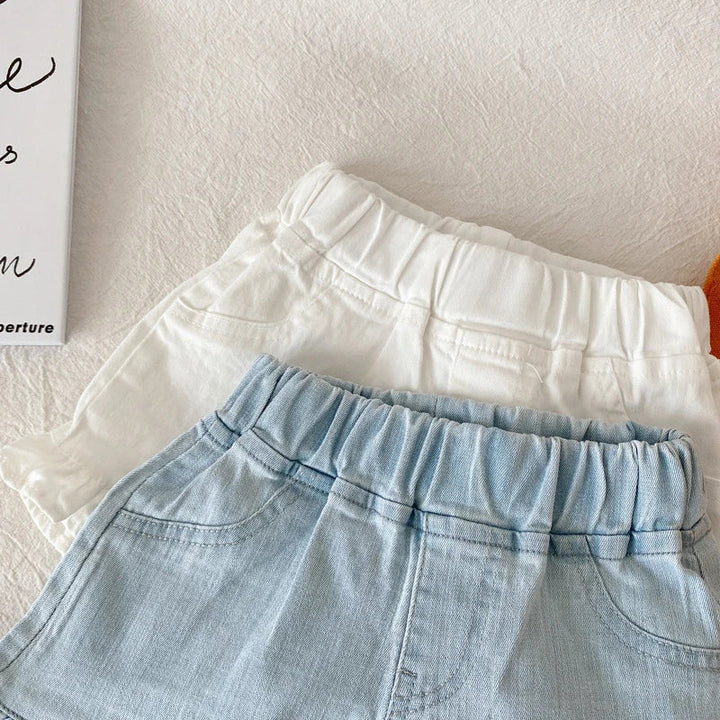 Girls' patterned cotton ruffle shorts with small dots, a fun summer fashion choice.