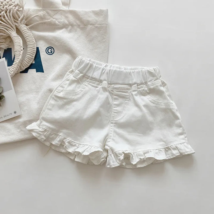 Side view of girls' cotton ruffle shorts, showing the layered ruffle detail clearly.