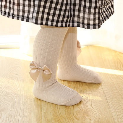 Side view of girls' pink cotton bow socks, showing ankle length and neat stitching, toddler socks