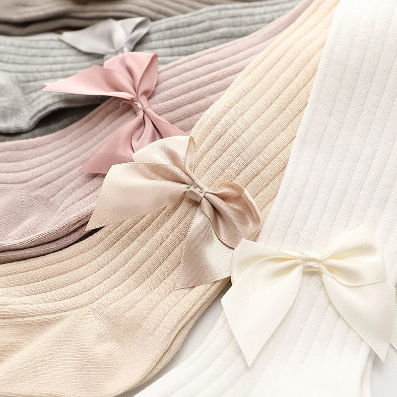 Stylish girls' white cotton socks featuring a prominent bow, a must-have baby accessory