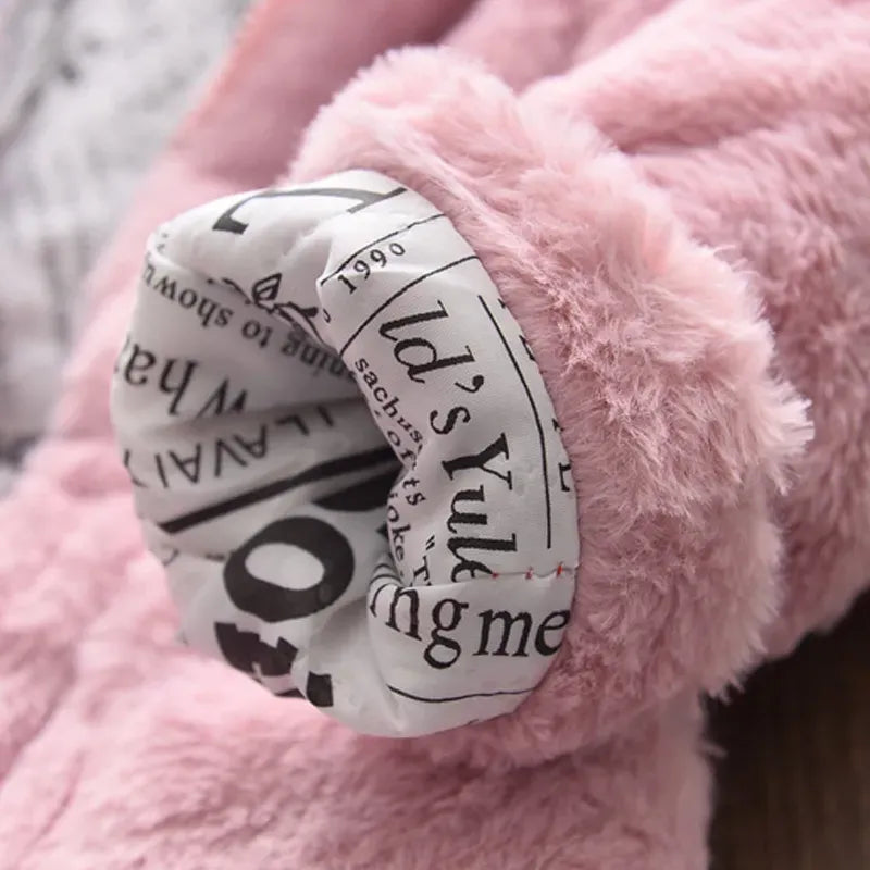 Stack of colorful girls' winter coats with faux fur hoods: pink, red, white
