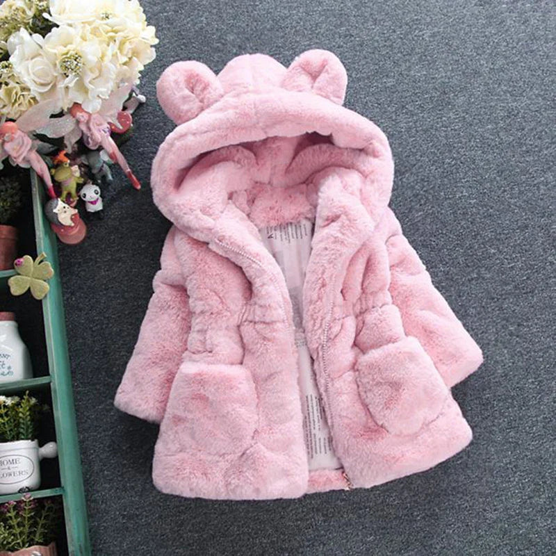 Close-up of faux fur hood on a girls' winter coat, soft and warm