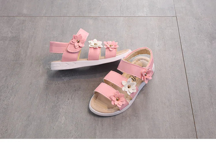 A single girl's floral gladiator sandal, highlighting its craftsmanship and details