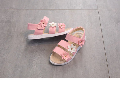 A single girl's floral gladiator sandal, highlighting its craftsmanship and details