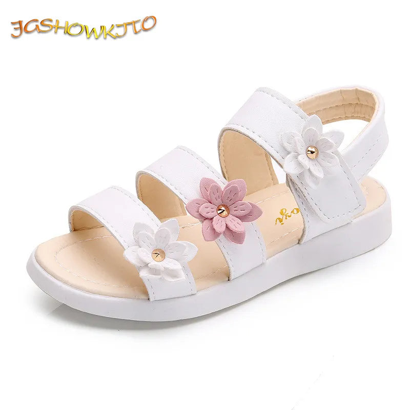 Close-up of a girl's white floral gladiator sandal with intricate flower details