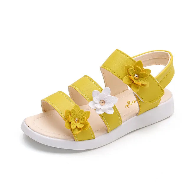 Close-up of the ankle strap and floral embellishments on a princess gladiator sandal