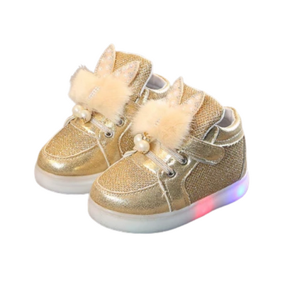 Close-up of a girl's pink furry rabbit ear LED light-up shoe, showcasing the soft texture and vibrant light