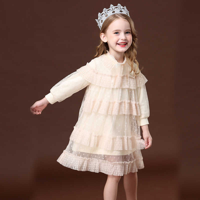 Toddler girl in an elegant white layered lace puff sleeve dress, perfect for special occasions.