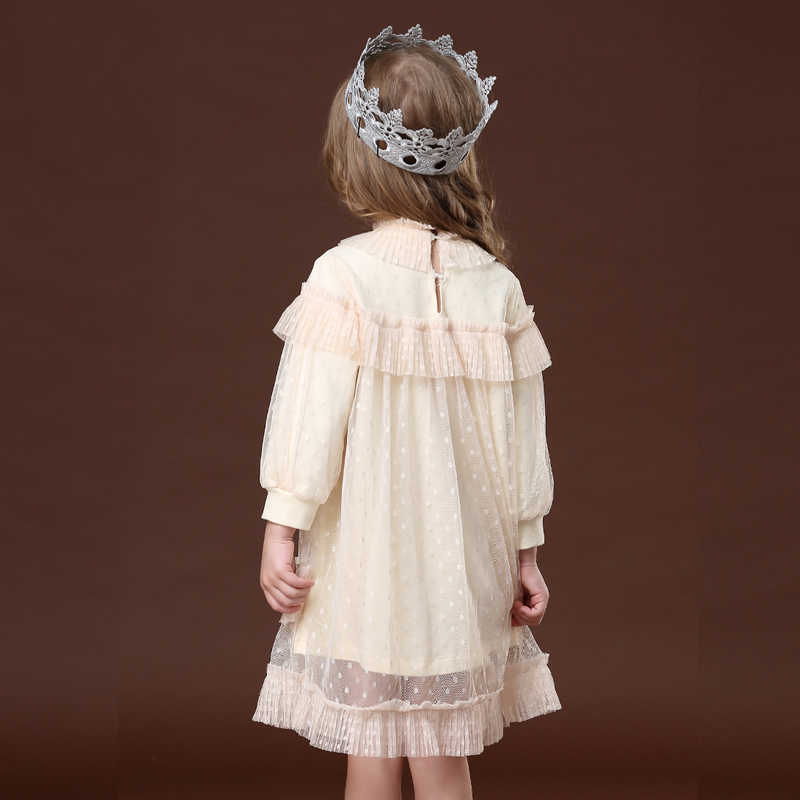 Close-up of the delicate lace and ruffled detailing on a girls' princess party dress sleeve.