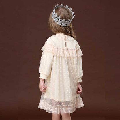 Close-up of the delicate lace and ruffled detailing on a girls' princess party dress sleeve.