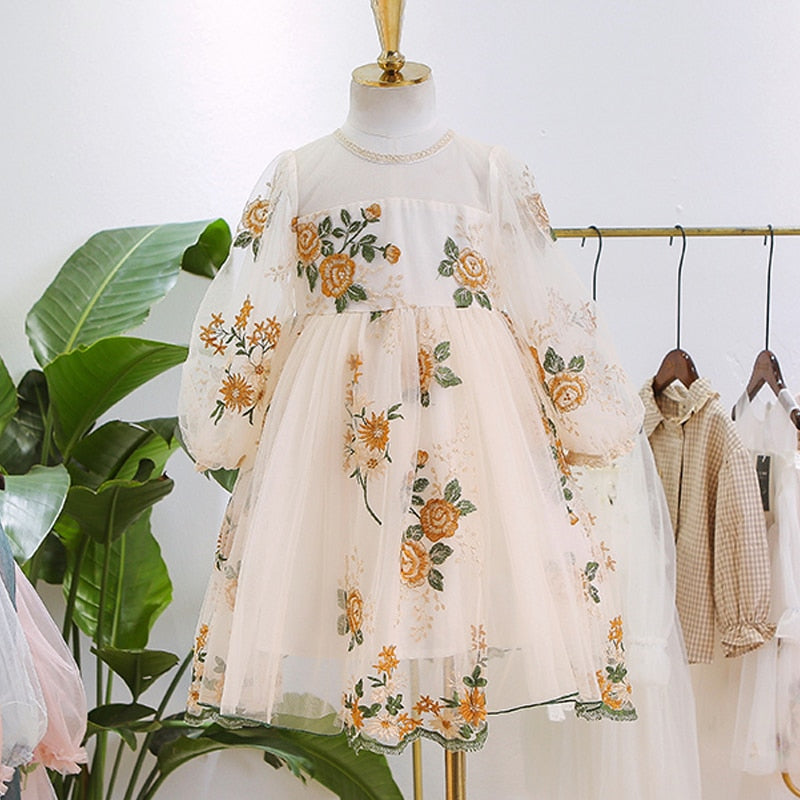 Happy child twirling in a beautiful cotton girls' pink lace puff sleeve birthday dress.