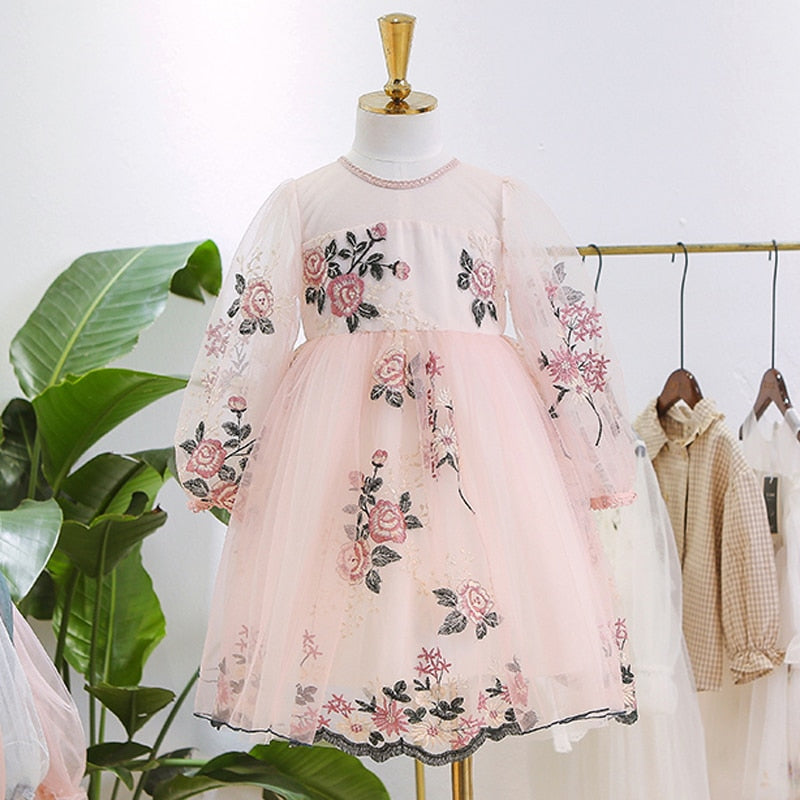 A charming display of a girls' white layered lace ruffle princess dress on a hanger, kids fashion.