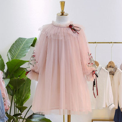Little girl wearing a blue layered lace ruffle puff sleeve dress, suitable for toddler fashion.