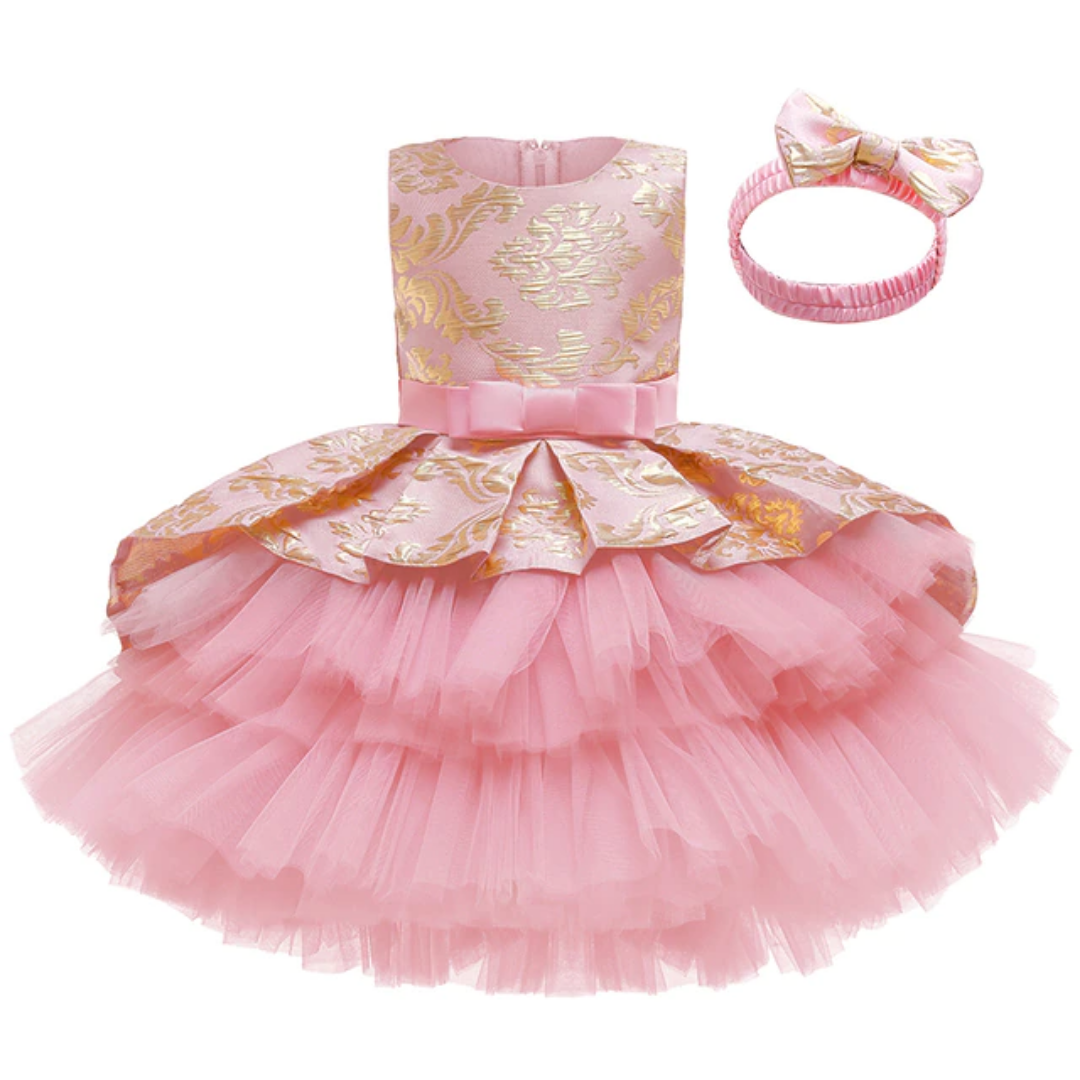 Toddler girl in a white layered tutu flower girl dress with a delicate headband set.