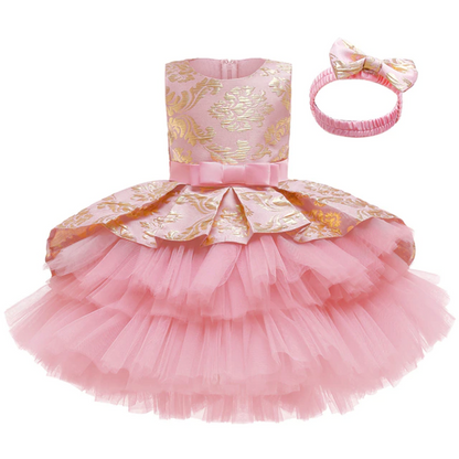 Toddler girl in a white layered tutu flower girl dress with a delicate headband set.