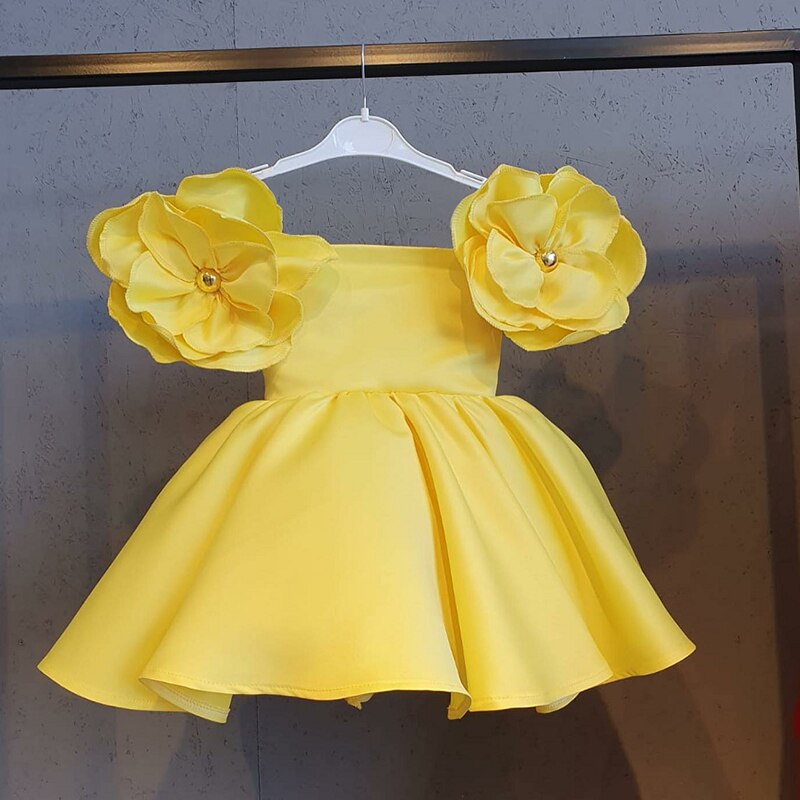Detailed view of the layered skirt on a girls' tutu dress with a matching hair accessory.