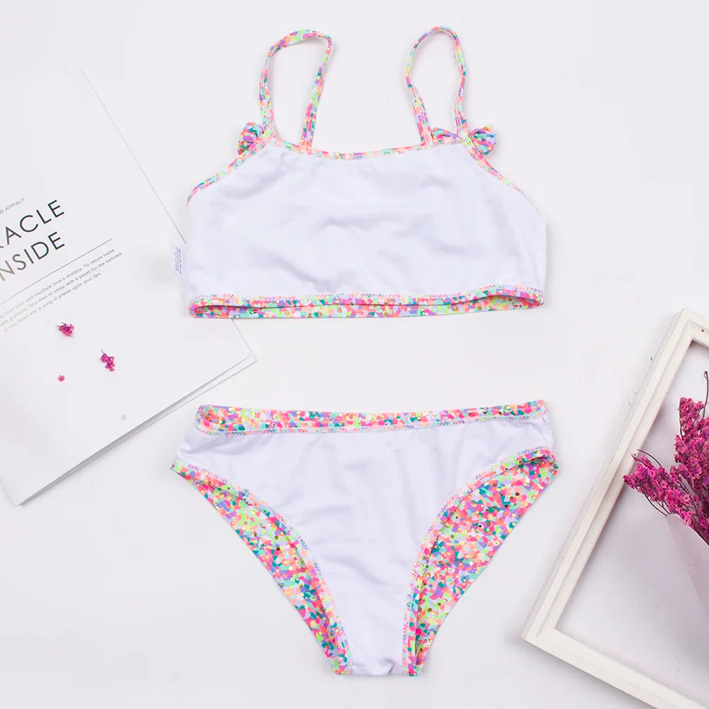 Back view of a girls' polka dot bikini set featuring a decorative bow, cute kids swimwear