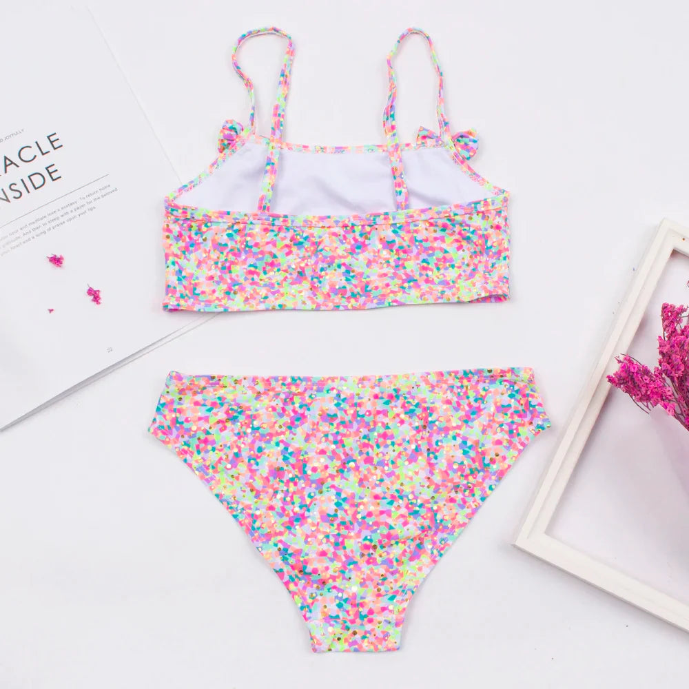 Close-up of bow deco on a girls' printed bikini top, perfect for a toddler's beachwear