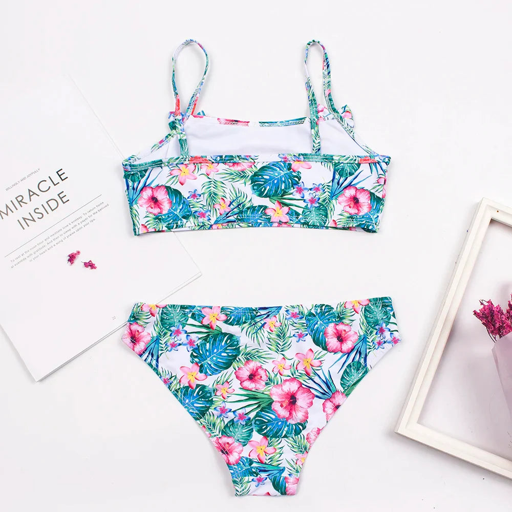 Happy girl wearing a vibrant polka dot bow deco bikini set, perfect for summer swimming