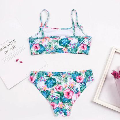 Happy girl wearing a vibrant polka dot bow deco bikini set, perfect for summer swimming