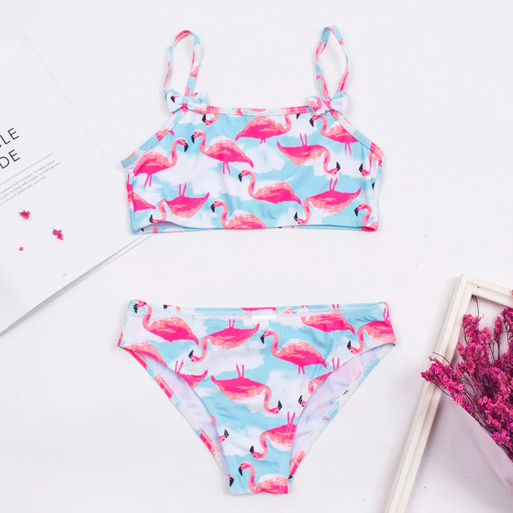 Detailed shot of quick-dry fabric on a girls' printed bikini, ideal for active children