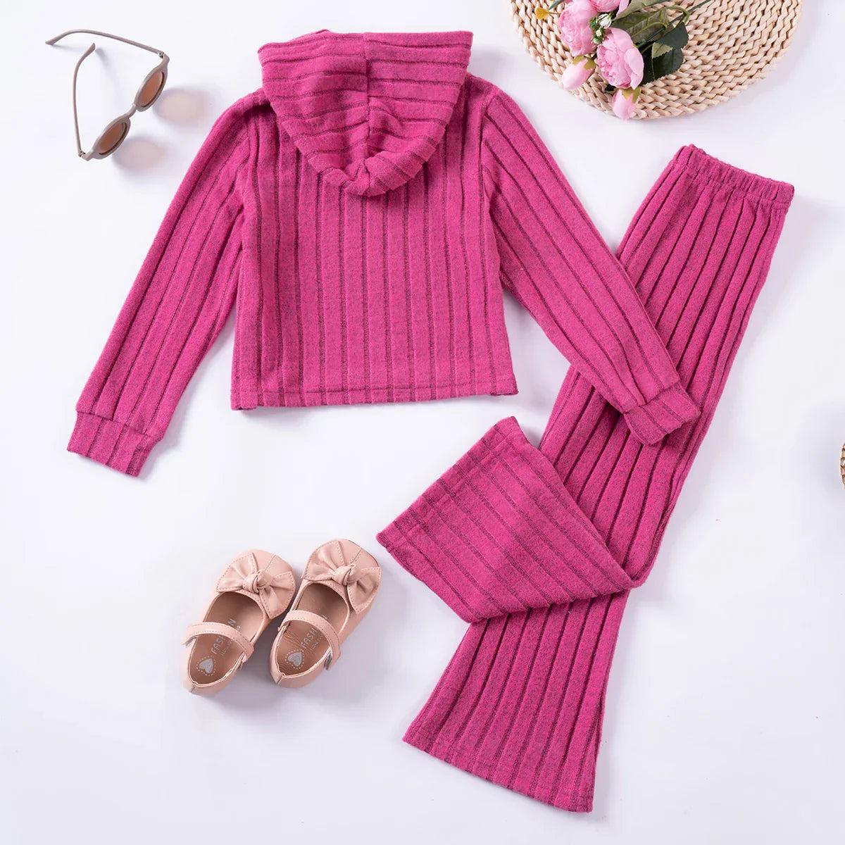 Toddler girl smiling in a comfy pink tracksuit, ideal kids fashion cozy winter outfit.