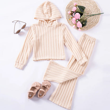 A pink girls' tracksuit set laid flat, showcasing soft, warm polyester for winter kids fashion.