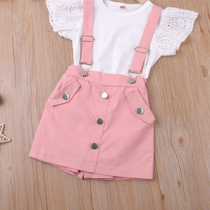 Toddler girl wearing a pink princess fashion shorts set, ideal for summer play, made from comfy cotton blend.