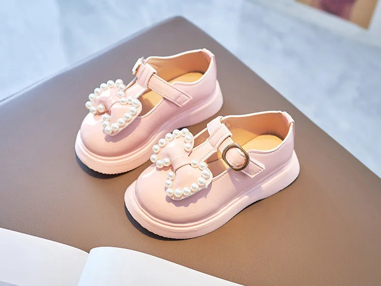 Back view of girls princess flats in pink, highlighting the elegant bow-knot and pearl details.