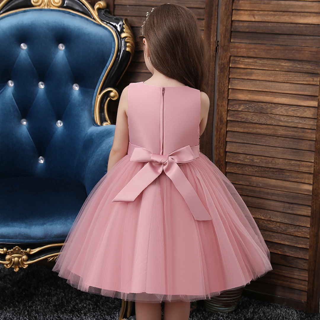 Close-up of pearl and sequin detailing on bodice of a girls' festive party dress, toddler size
