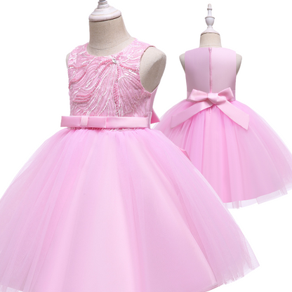 Toddler girl in a beautiful pearl and sequin embellished princess party dress, ready for celebration