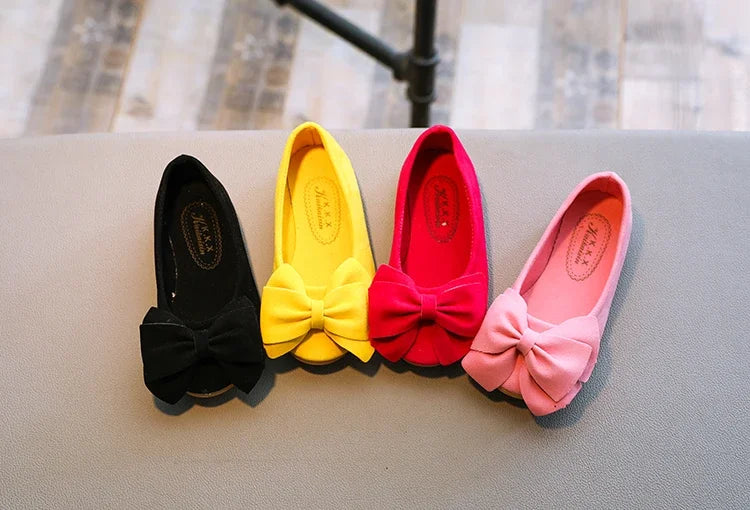 Orange kids' slip-on bowtie sandals, a bright and fun option for summer footwear