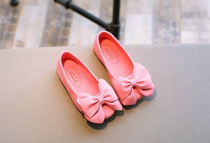 Red girls' slip-on fashion sandals featuring a playful bowtie, great for active kids