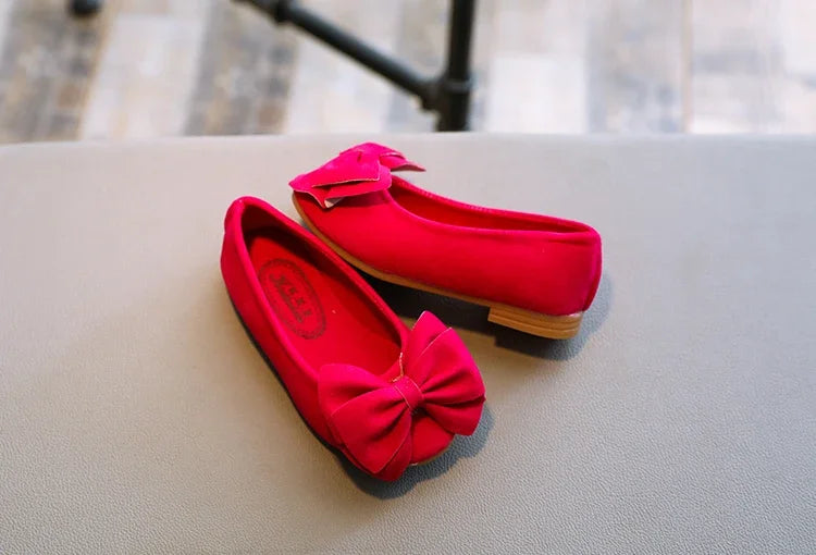 Orange kids' fashion sandals with a decorative bowtie, perfect for summer playtime