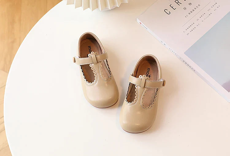 Child's foot in a purple retro T-strap flat, vintage princess dress shoe, comfy for all-day wear