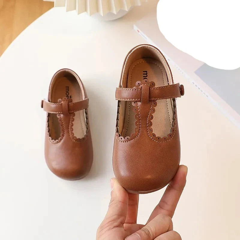 Pair of yellow girls' retro T-strap flats, vintage princess dress shoes, for spring autumn fashion