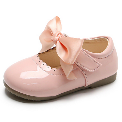 Pair of black girls' party shoes, featuring ribbon lace and a bow, chic slip-on toddler fashion footwear