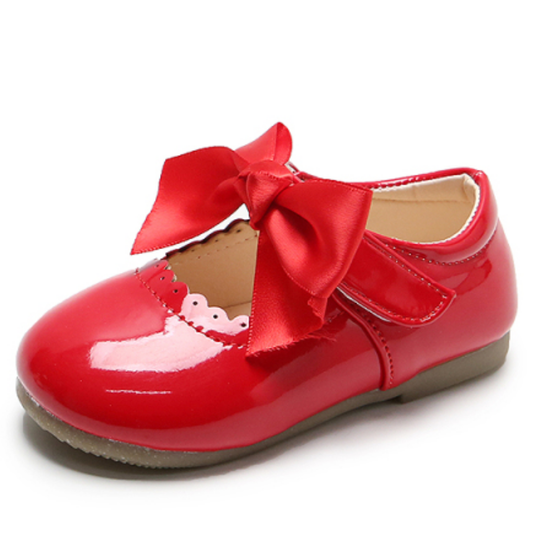 Cute pink girls' bow shoes with intricate lace, ideal princess footwear for parties and special occasions