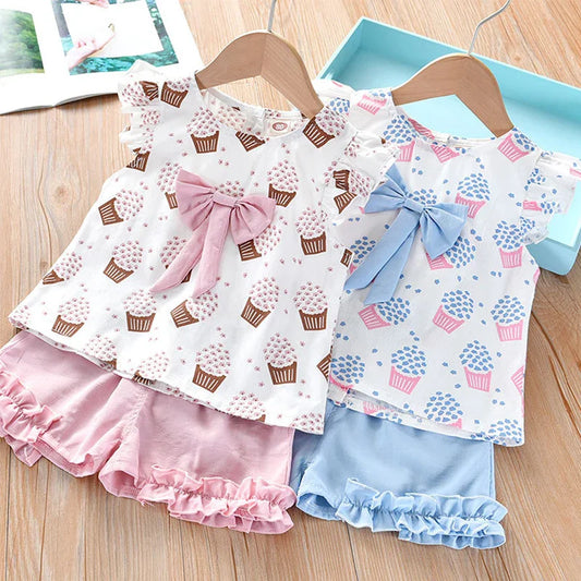 Girls pink sleeveless outfit with ice cream print and bow, perfect for summer playwear