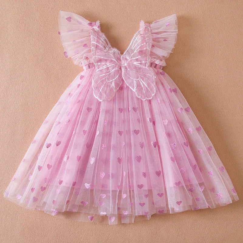 Girls' pink tulle party dress with back bow and wing details, perfect for a birthday princess.