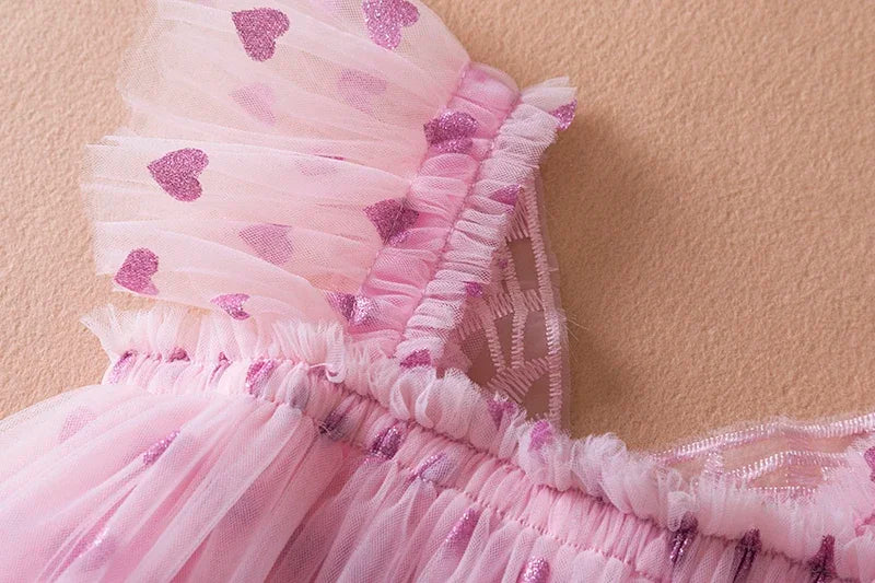 Girls' fashion: A pristine white back bow wing tulle party dress, perfect for a photo shoot.