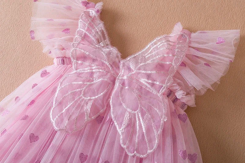 Chic purple girls' party dress, a winged tulle design with a statement back bow for toddlers.