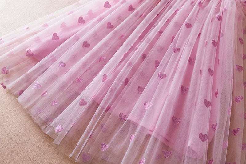 Back view of a white back bow wing tulle party dress for girls, highlighting its beautiful design.
