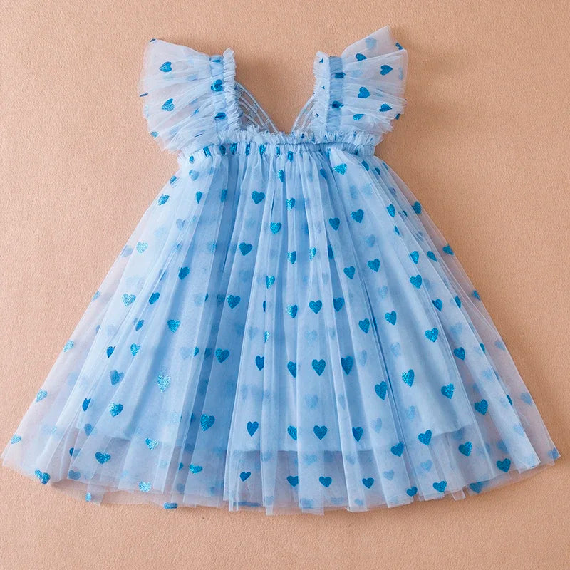 Full-length image of a girl in a white back bow wing tulle party dress, a true princess style.