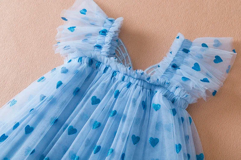 Girls' fashion inspiration: A pink back bow wing tulle party dress with a delicate, airy feel.