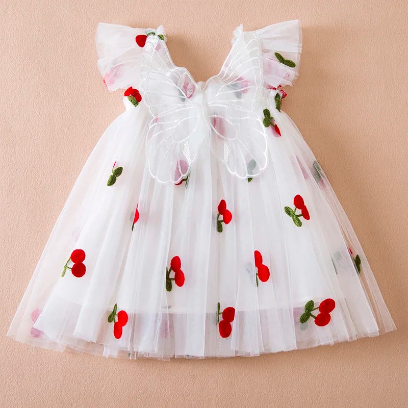 Adorable pink toddler dress with a large back bow and subtle wing design, made from soft tulle.