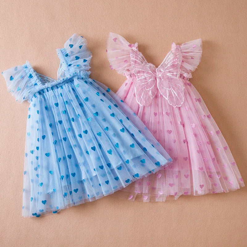 Elegant purple girls' birthday dress, a tulle gown with a prominent back bow and whimsical wings.
